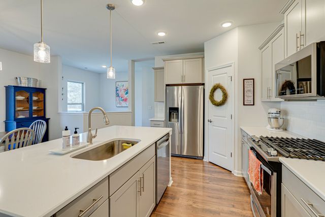 a kitchen with refrigerator a sink and cabinets