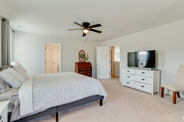 a bedroom with a bed and a television