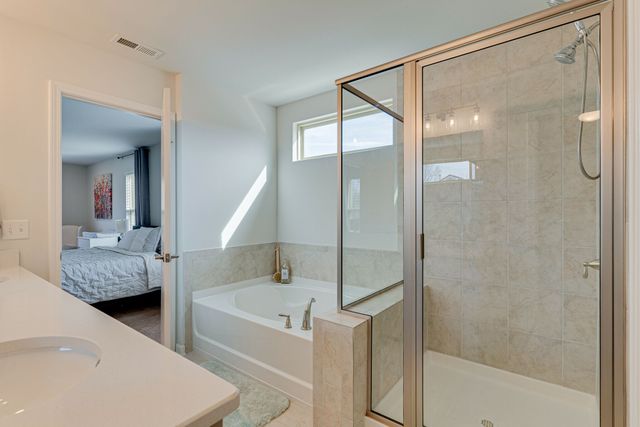 a bathroom with a bathtub and a shower