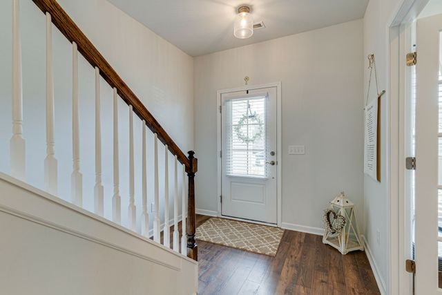 a view of an entryway with wooden floor and stairs