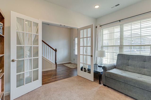 a living room with furniture and windows