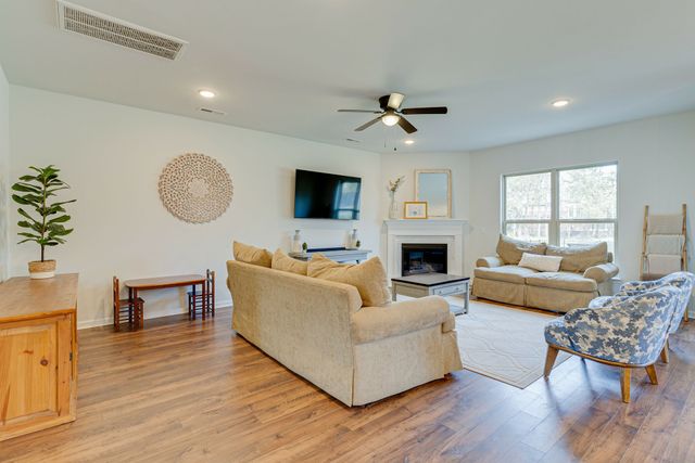 a living room with furniture fireplace and a flat screen tv
