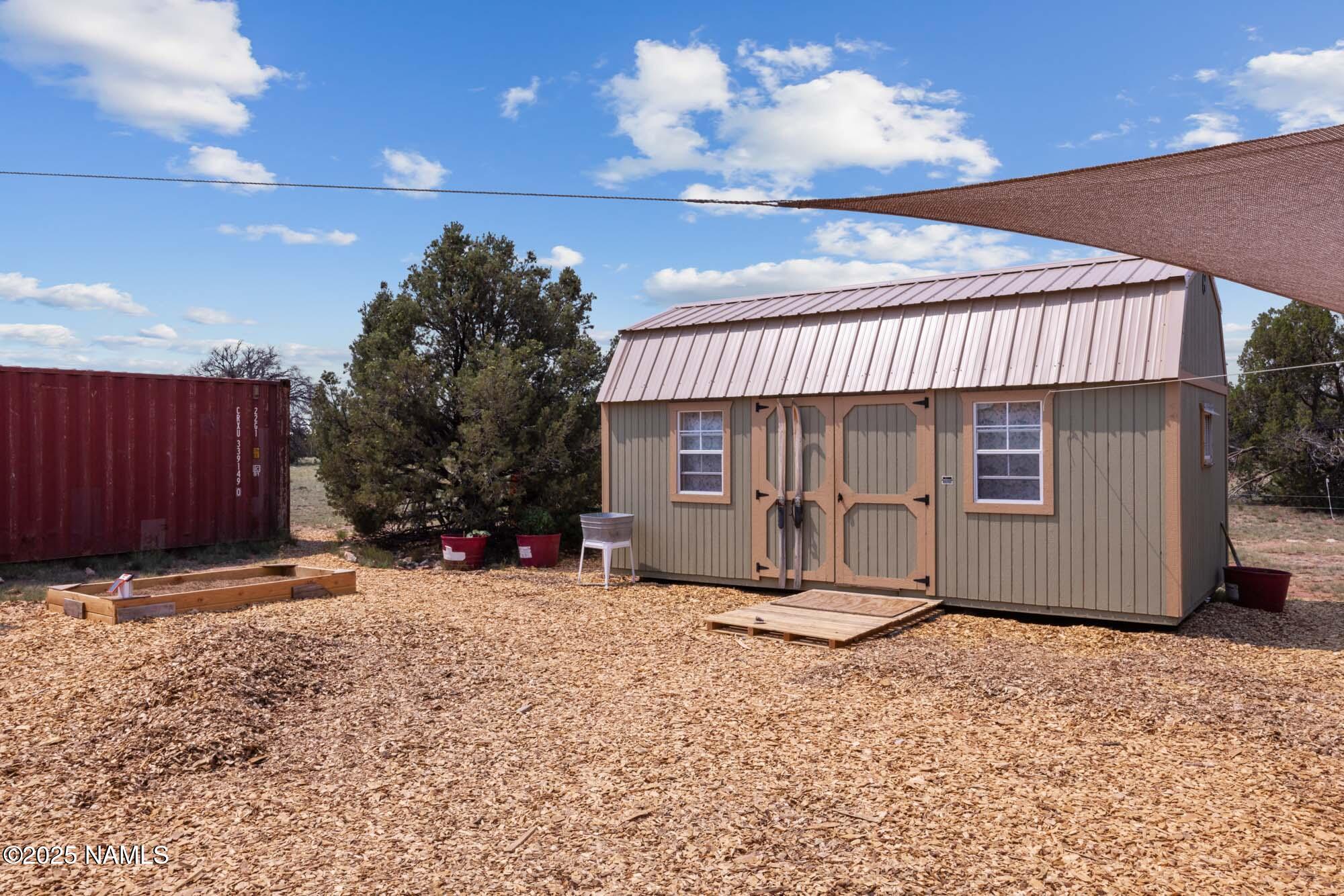 10448 South Rim Ranch Road Williams, AZ 86046 - Photo 12 of 60 a view of a house with a patio and wooden fence