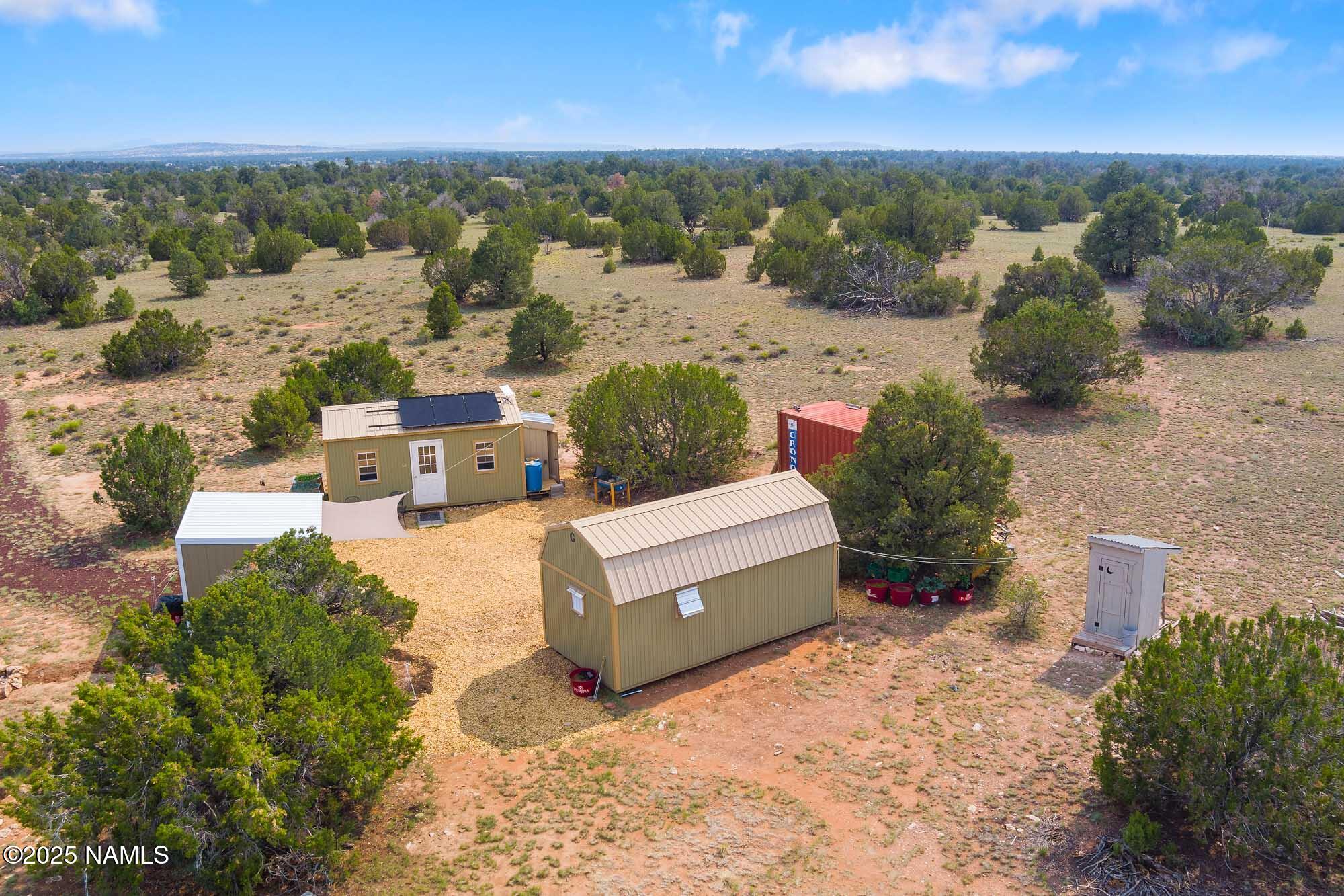 10448 South Rim Ranch Road Williams, AZ 86046 - Photo 4 of 60 an aerial view of a house with yard and ocean view