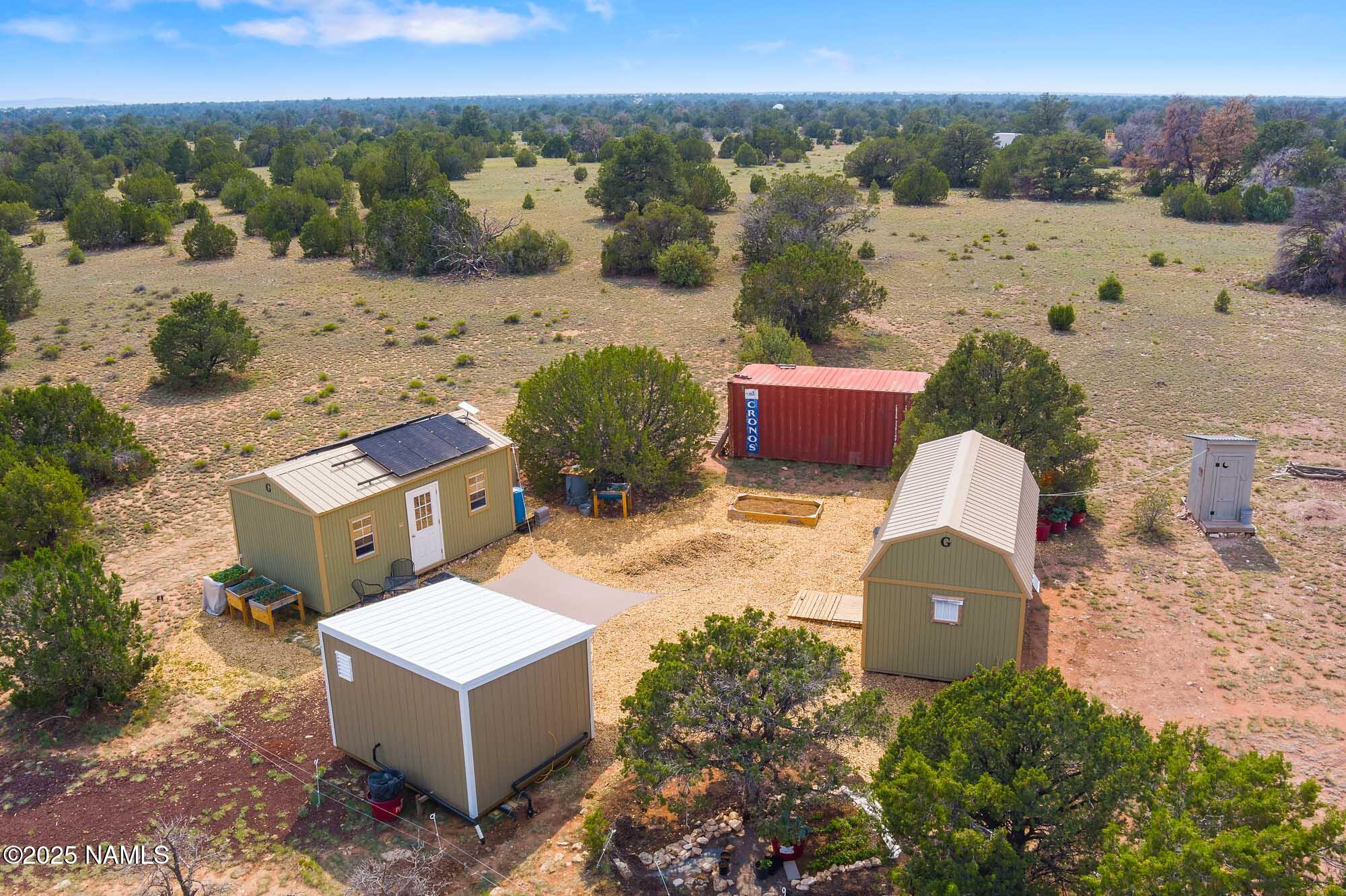 10448 South Rim Ranch Road Williams, AZ 86046 - Photo 5 of 60 an aerial view of a house with a yard