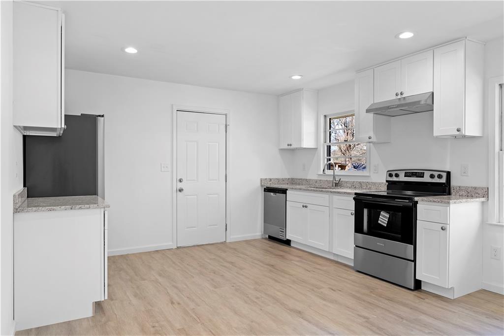 1802 Lake Harbin Road Morrow, GA 30260 - Photo 1 of 40 a kitchen with a sink a stove and cabinets