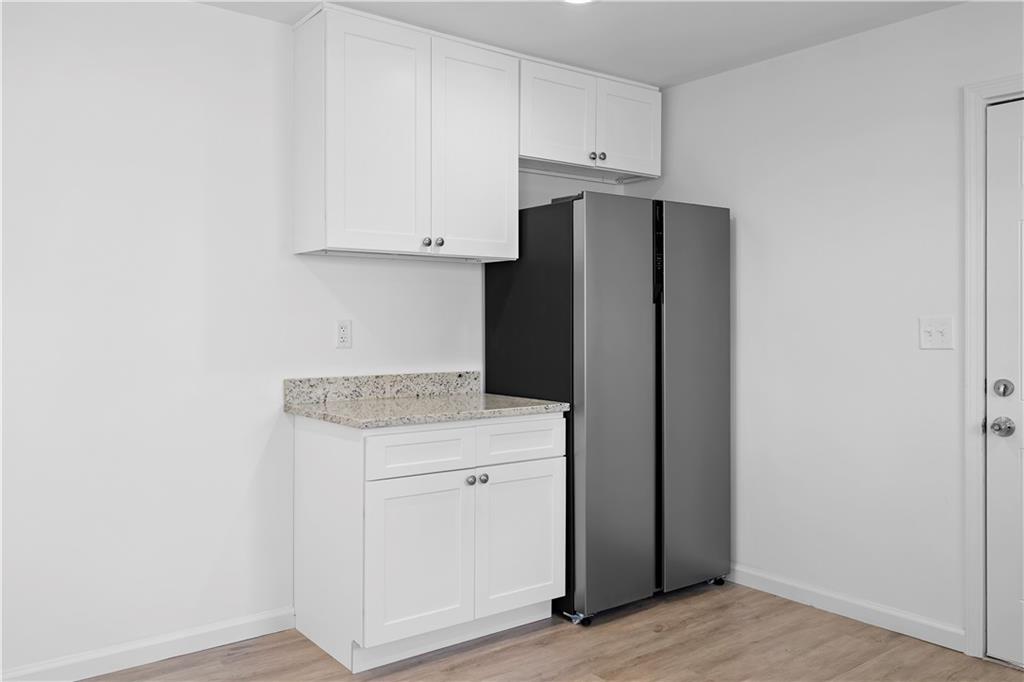 1802 Lake Harbin Road Morrow, GA 30260 - Photo 11 of 40 a kitchen with white cabinets and refrigerator