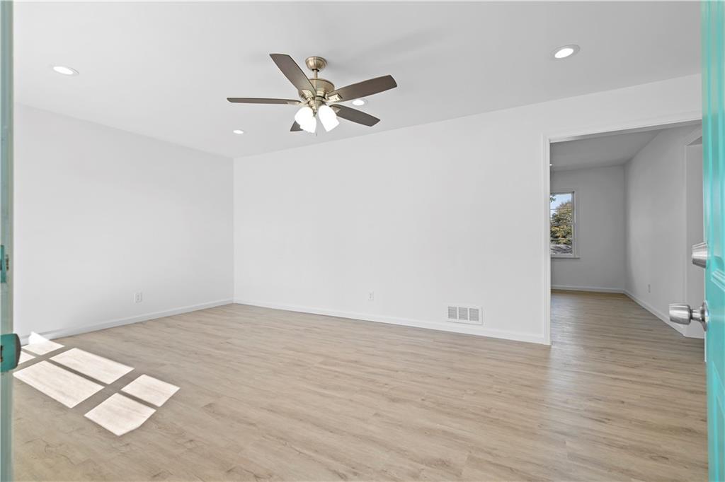 1802 Lake Harbin Road Morrow, GA 30260 - Photo 15 of 40 an empty room with wooden floor and windows