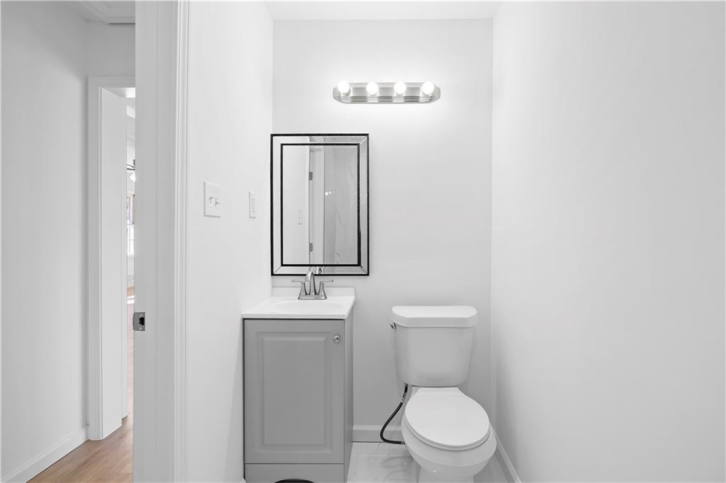 1802 Lake Harbin Road Morrow, GA 30260 - Photo 16 of 40 a white toilet sitting next to a bathroom sink