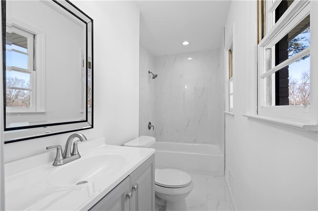 1802 Lake Harbin Road Morrow, GA 30260 - Photo 20 of 40 a bathroom with a sink a toilet and shower
