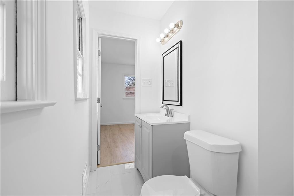 1802 Lake Harbin Road Morrow, GA 30260 - Photo 21 of 40 a white toilet sitting next to a bathroom sink