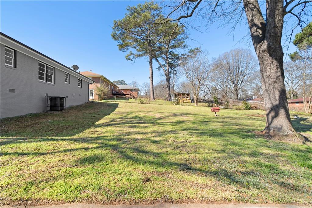 1802 Lake Harbin Road Morrow, GA 30260 - Photo 25 of 40 a swimming pool with trees in the background