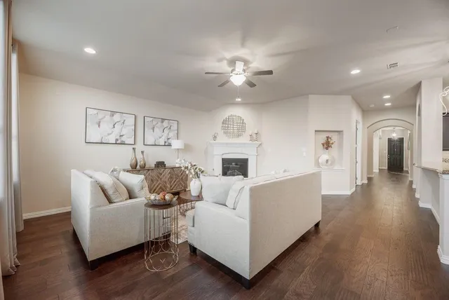 a spacious bedroom with a bed and a chandelier