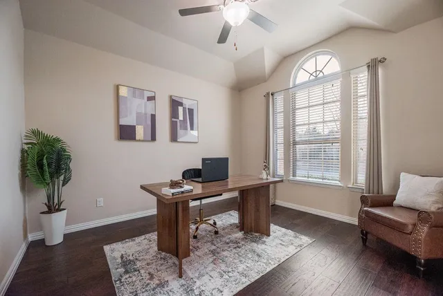 a work room with furniture and a potted plant