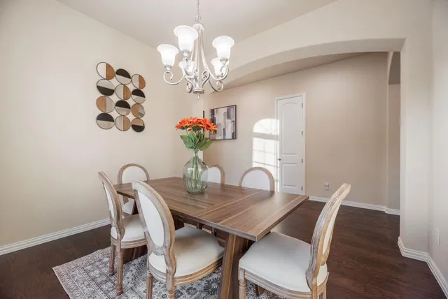 a view of a dining room with furniture wooden floor and chandelier