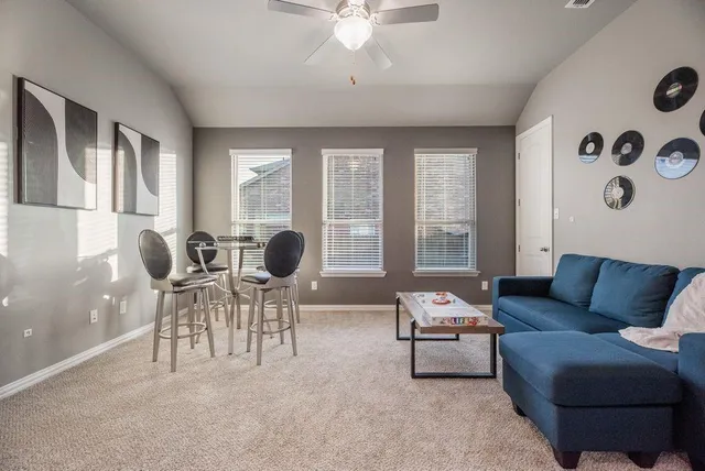 a living room with furniture and a large window
