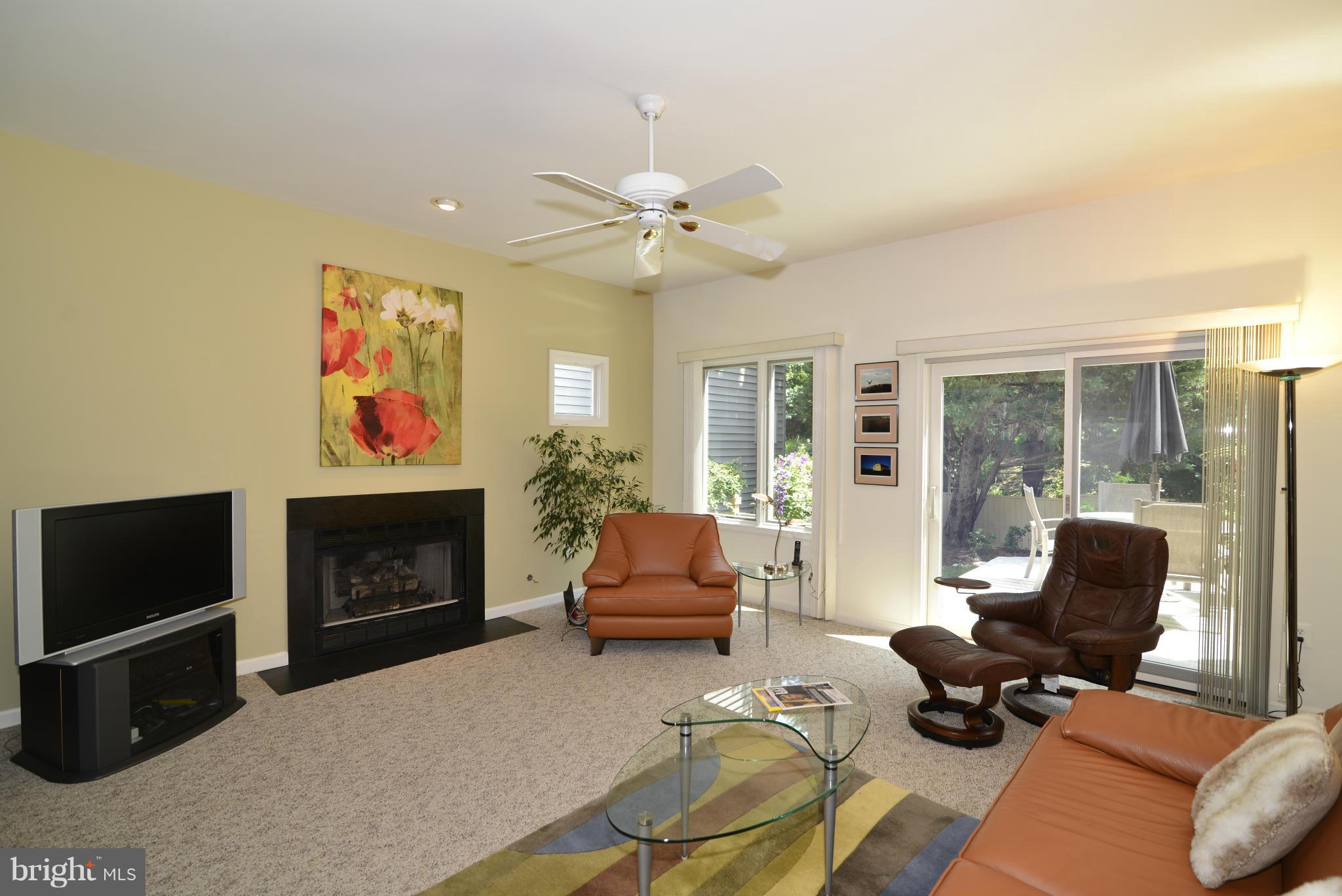 2015 Beacon Place Reston, VA 20191 - Photo 3 of 22 a living room with furniture a flat screen tv and a fireplace