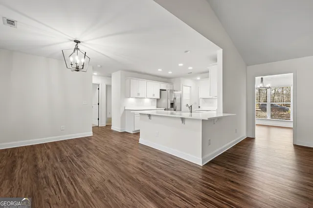 a view of kitchen with granite countertop cabinets and wooden floor