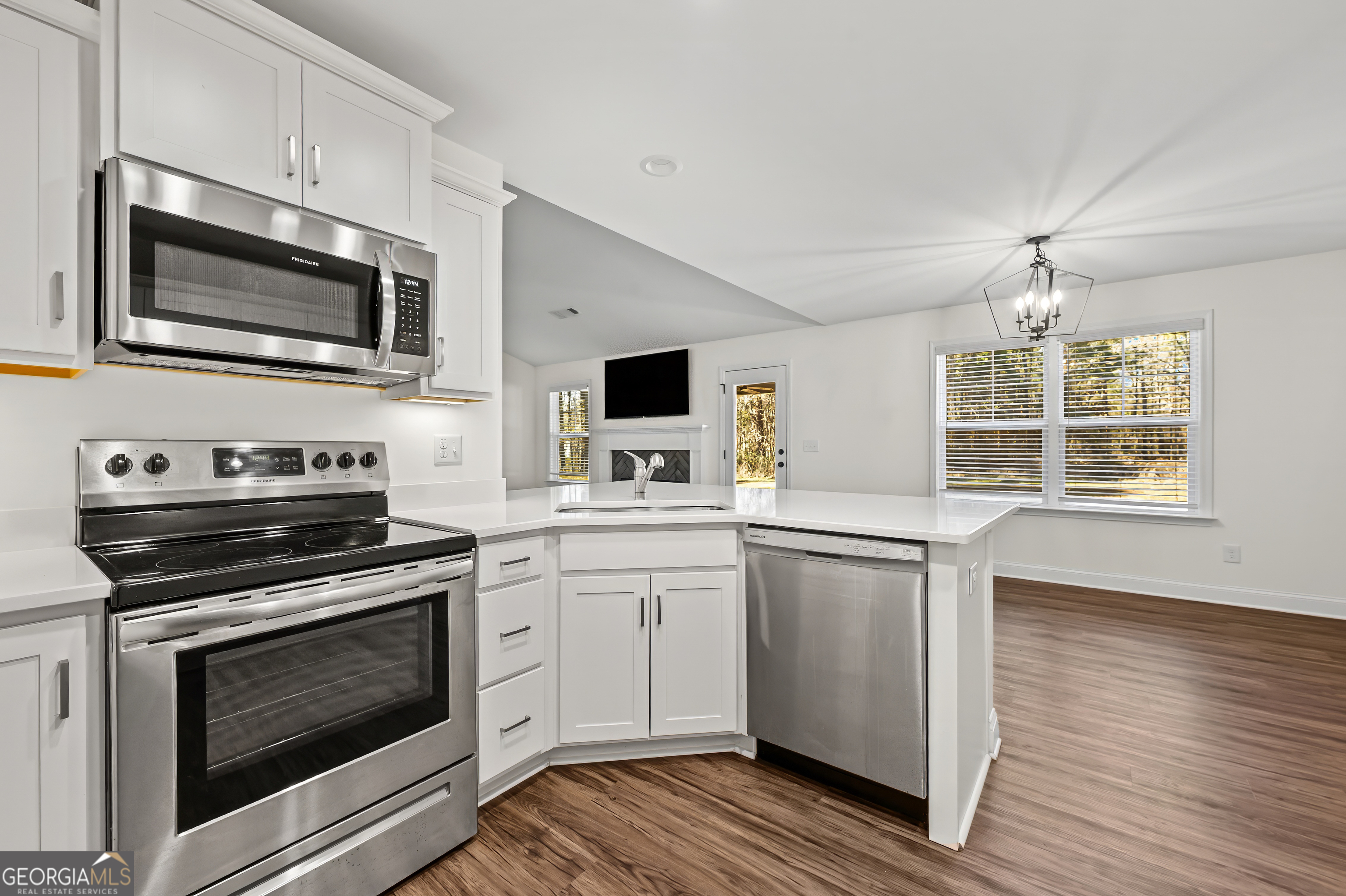 1788 Standing Rock Road Senoia, GA 30276 - Photo 13 of 36 a kitchen with stainless steel appliances a stove microwave and sink