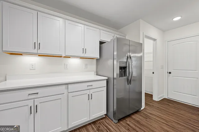 a kitchen with a refrigerator and cabinets