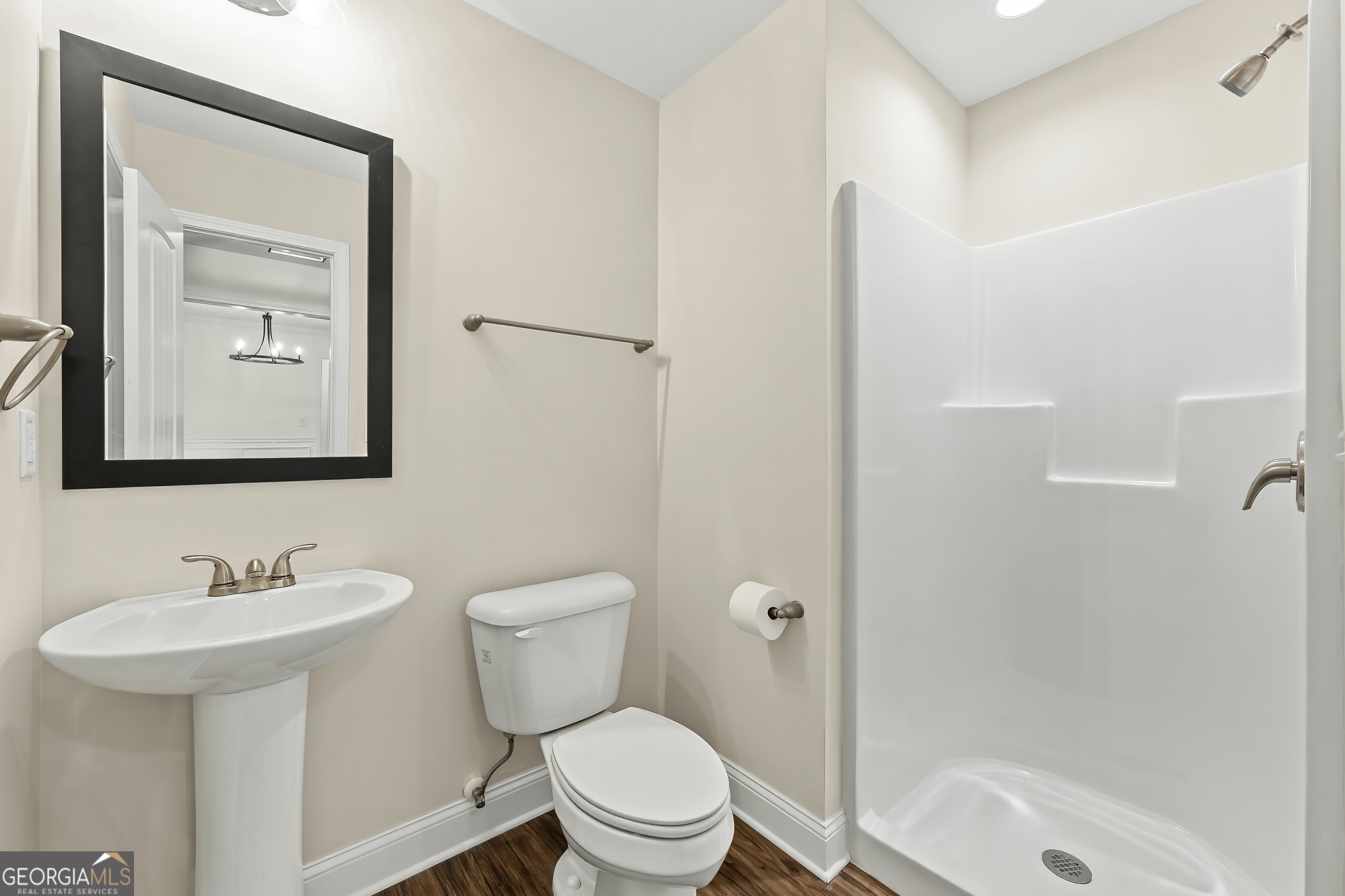 1788 Standing Rock Road Senoia, GA 30276 - Photo 18 of 36 a bathroom with a toilet a sink a mirror and shower