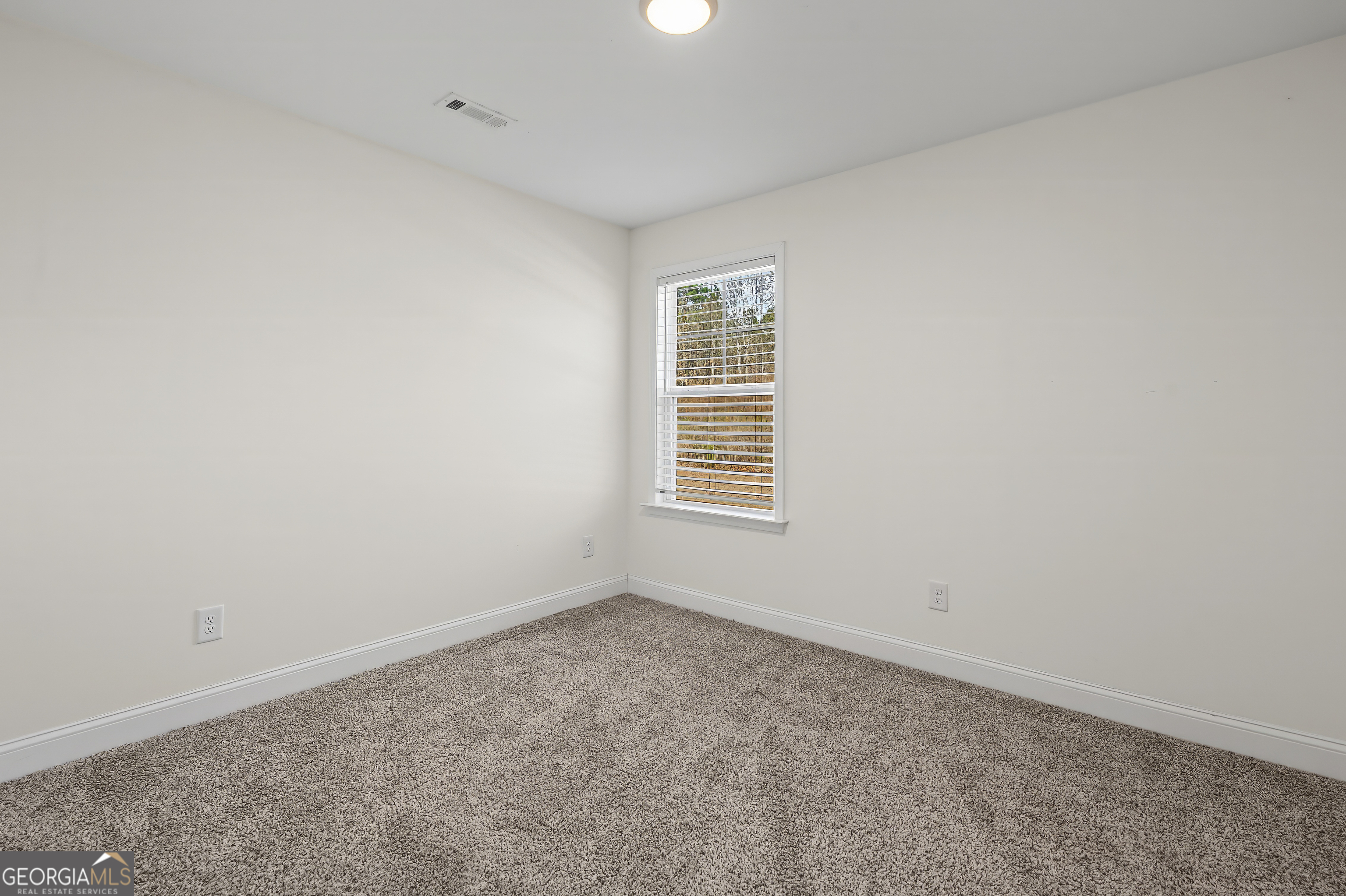 1788 Standing Rock Road Senoia, GA 30276 - Photo 19 of 36 an empty room with a window
