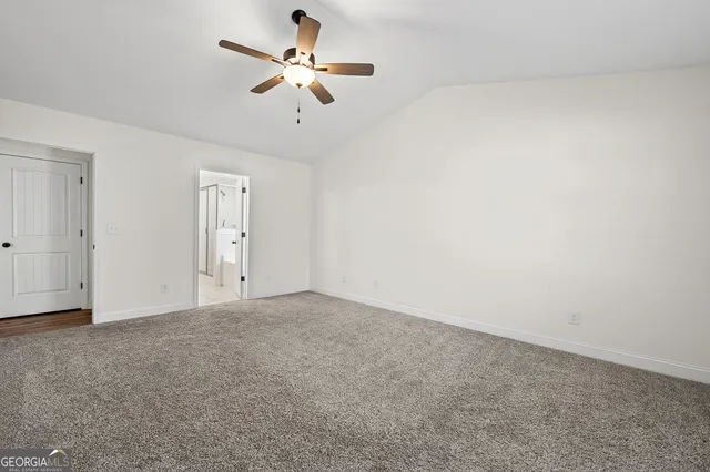 an empty room with a empty space and a ceiling fan