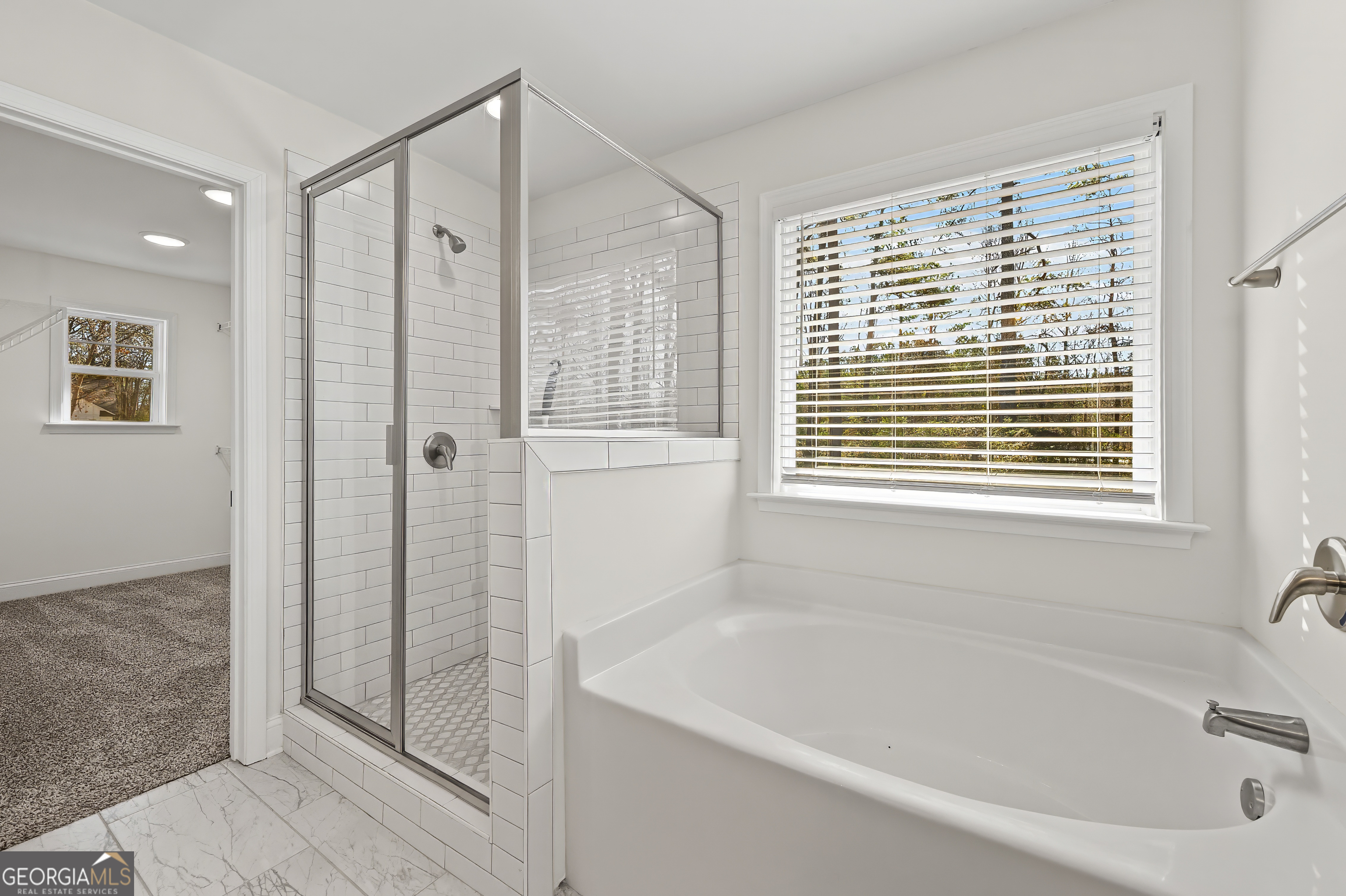 1788 Standing Rock Road Senoia, GA 30276 - Photo 30 of 36 a bathroom with a bathtub a shower and a window