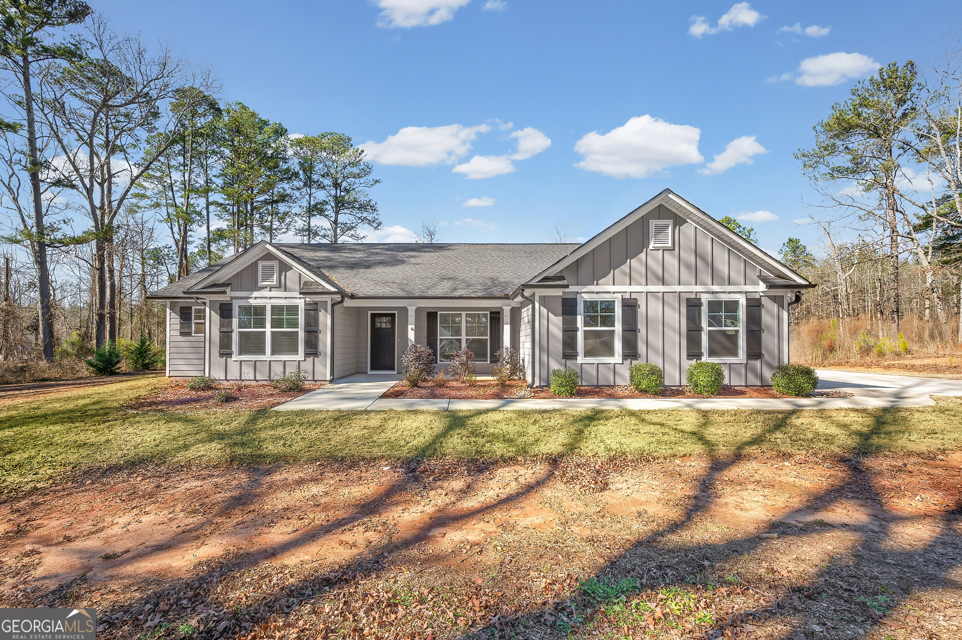 1788 Standing Rock Road Senoia, GA 30276 - Photo 3 of 36 a front view of a house with a yard