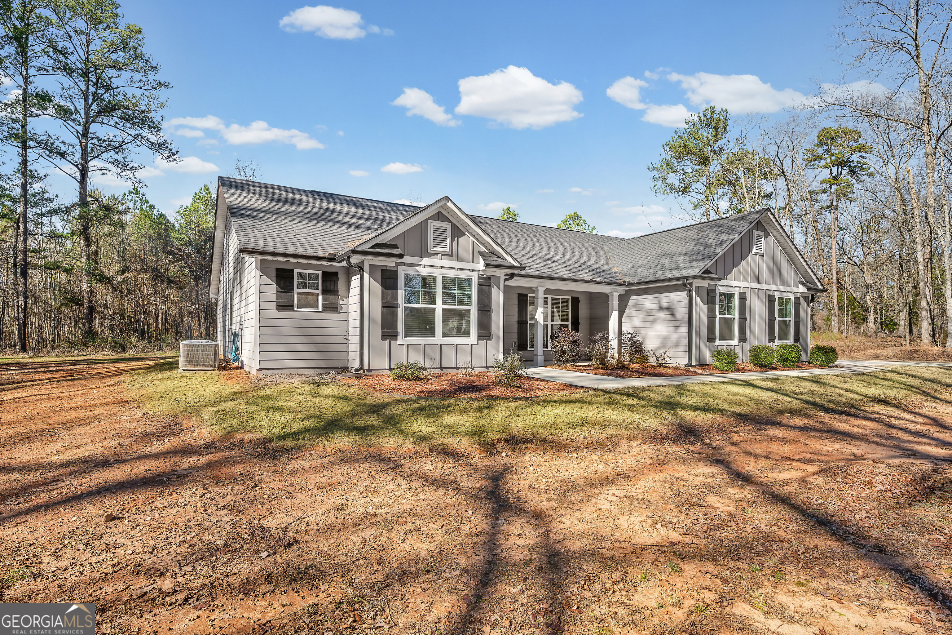 1788 Standing Rock Road Senoia, GA 30276 - Photo 4 of 36 a front view of a house with a yard