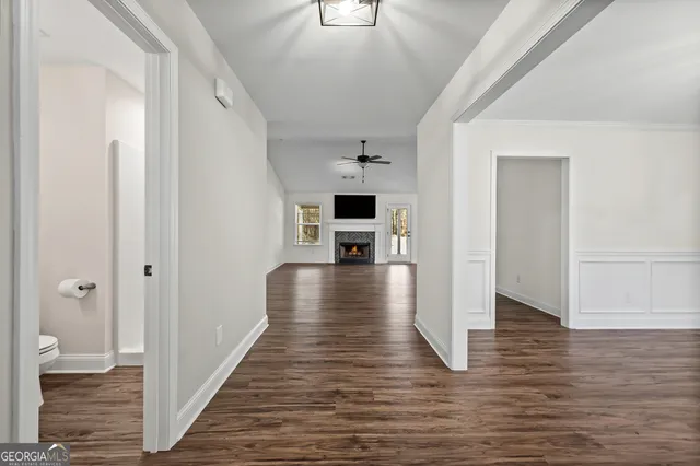 a view of a hallway view with wooden floor and staircase