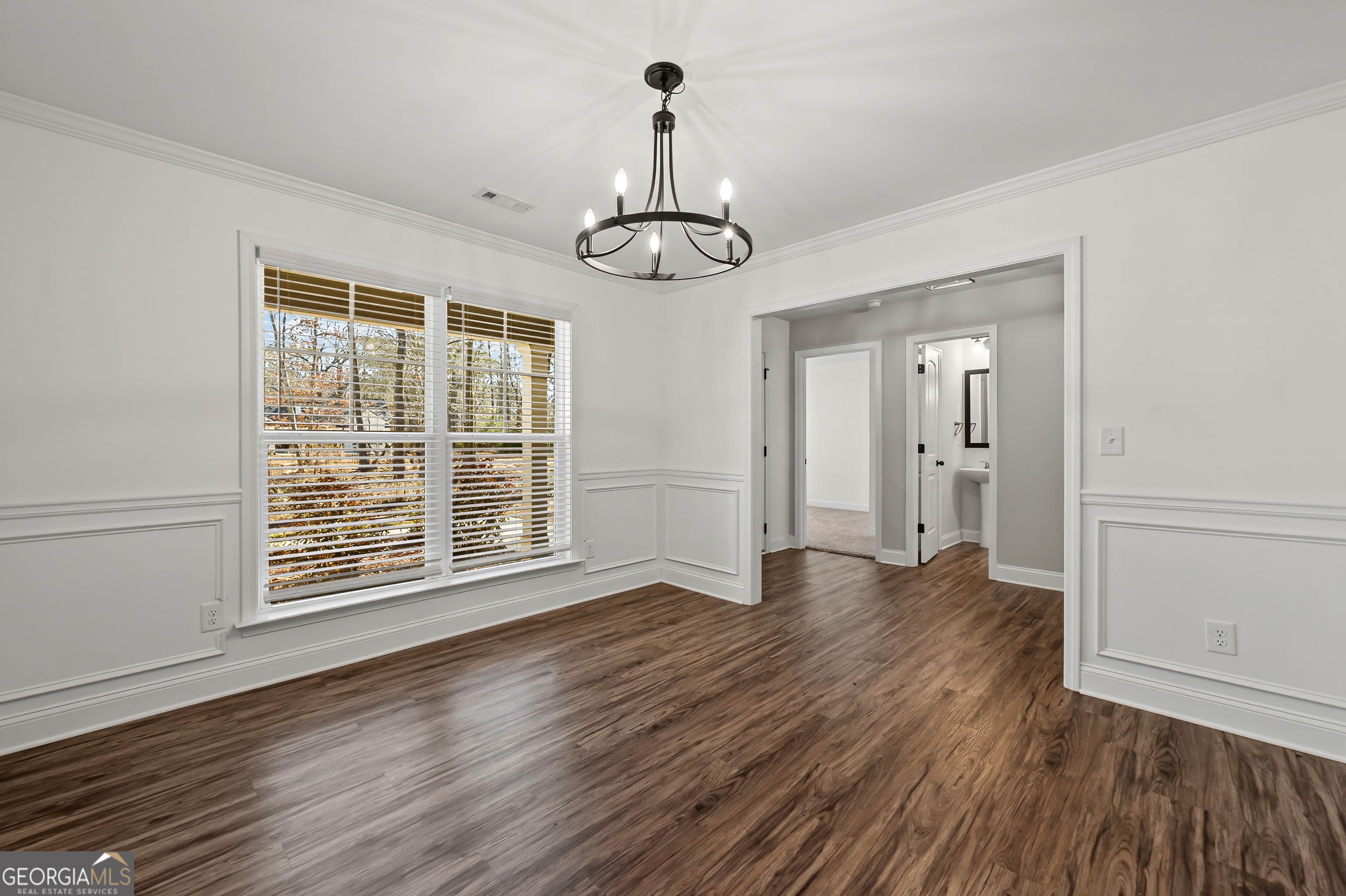 1788 Standing Rock Road Senoia, GA 30276 - Photo 8 of 36 a view of an empty room with wooden floor and windows