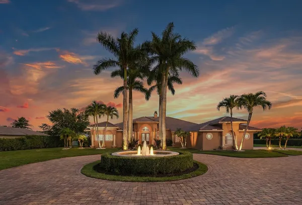 a front view of a house with a garden and yard