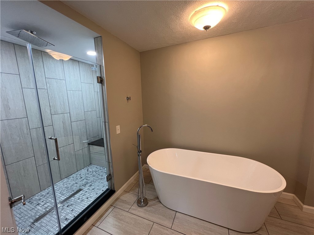 5105 Hillside Road Independence, OH 44131 - Photo 19 of 35 Bathroom featuring separate shower and tub, a textured ceiling, and tile floors