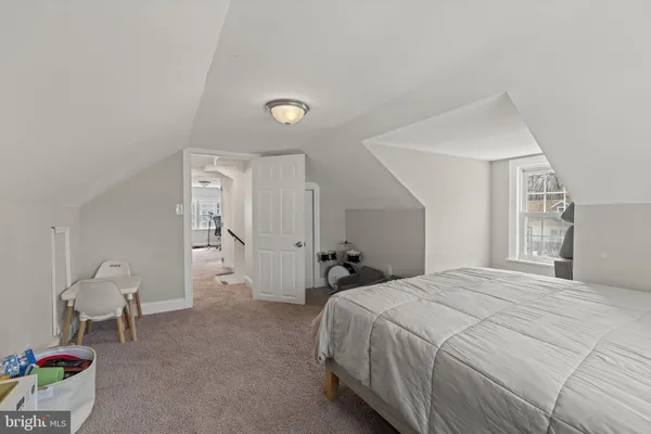 a spacious bedroom with a bed and a cabinets