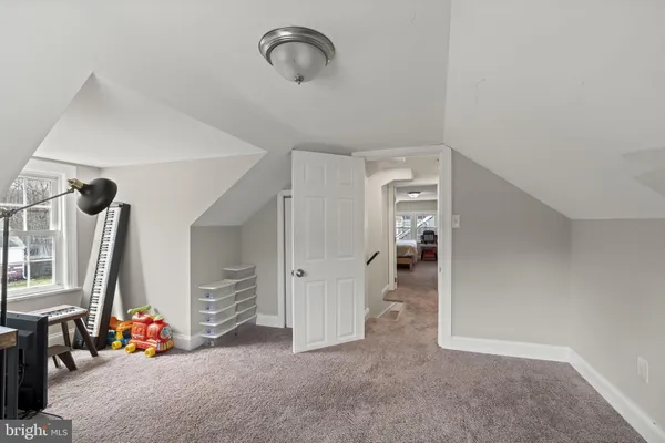 a view of a hallway and a livingroom with furniture