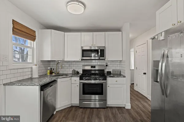 a kitchen with a sink stove and refrigerator