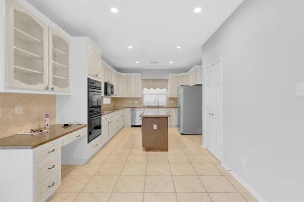 a kitchen with stainless steel appliances a refrigerator sink and cabinets