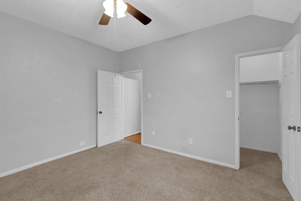 3714 Cedar Glen Lane Spring, TX 77388 - Photo 19 of 29 Unfurnished bedroom with a walk in closet, light colored carpet, lofted ceiling, and ceiling fan