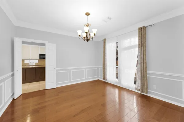 a view of a kitchen with granite countertop a refrigerator and a stove top oven