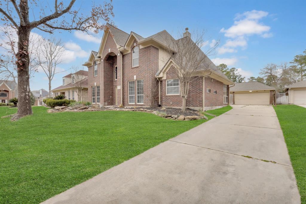 3714 Cedar Glen Lane Spring, TX 77388 - Photo 2 of 29 Traditional home featuring brick siding, a front yard, a garage, a chimney, and an outdoor structure