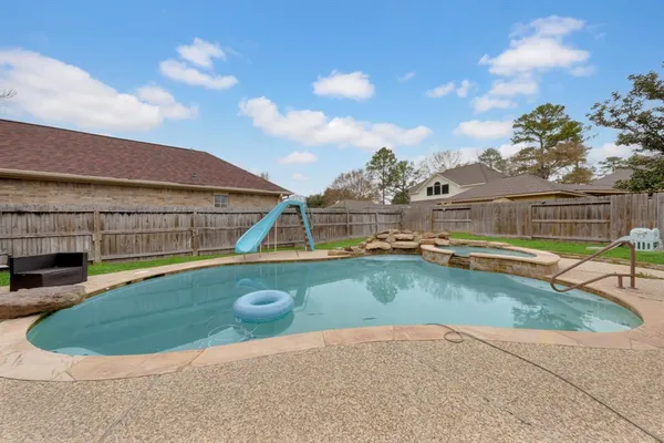 a view of a swimming pool with a yard