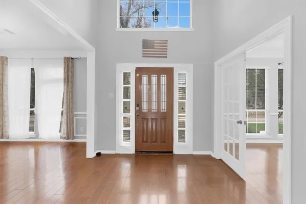 a view of an entryway with wooden floor