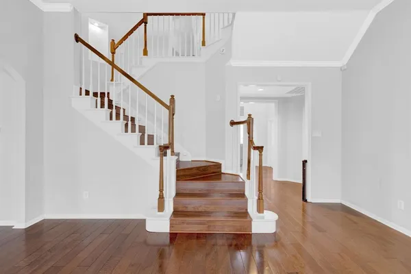 a view of entryway and hall with wooden floor