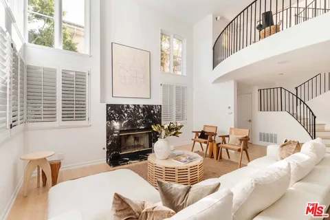 a living room with furniture a window and a fireplace