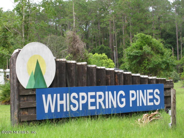 a view of sign board with a wooden fence
