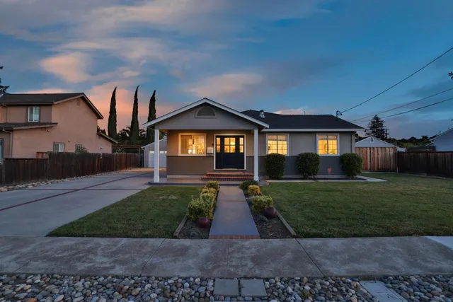 a front view of a house with garden