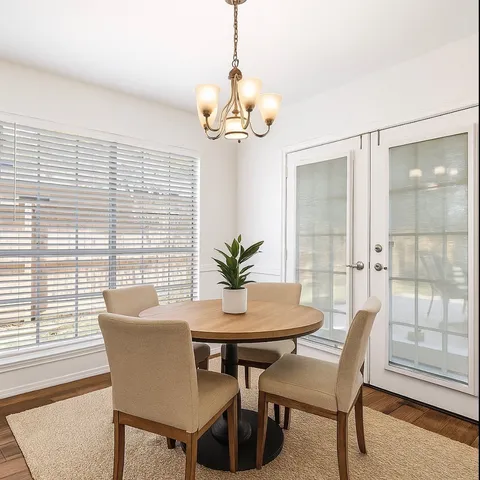 a dining room with furniture a chandelier and wooden floor