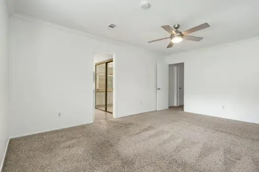 a view of an empty room with a fan