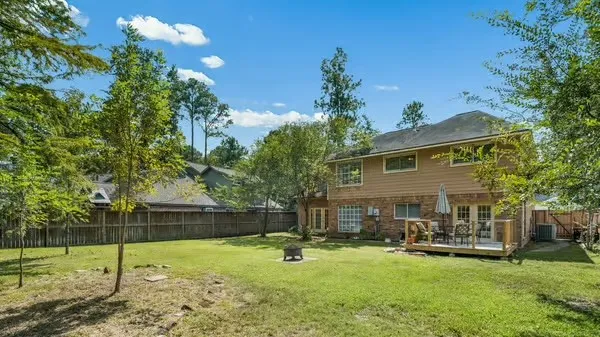 a backyard of a house with table and chairs